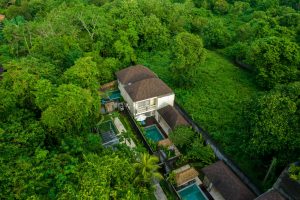 An aerial view of a house surrounded by trees