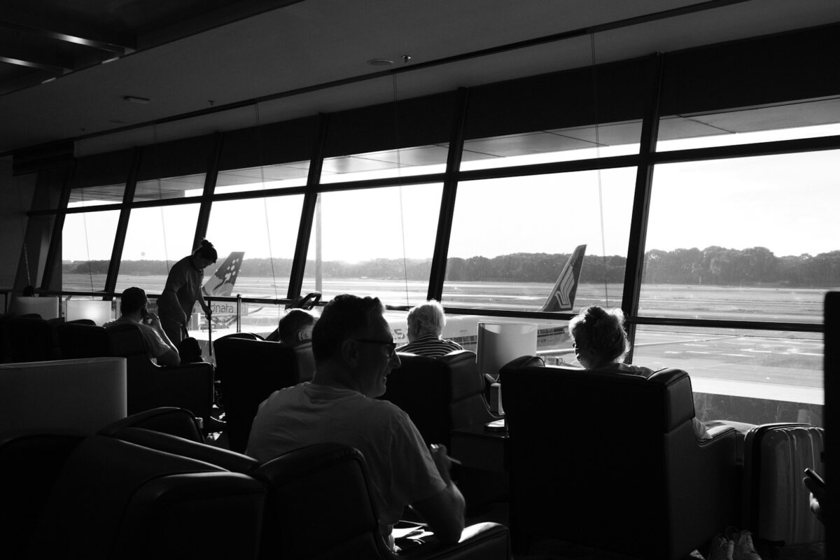 A group of people sitting in front of a window