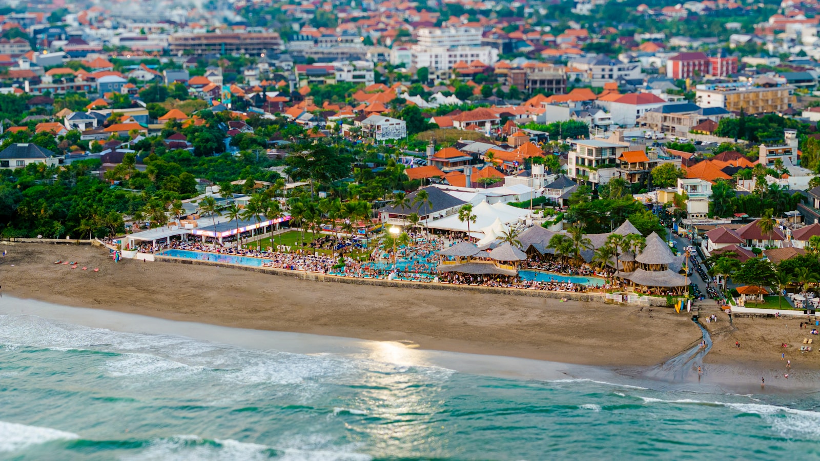 An aerial view of a beach with a city in the background