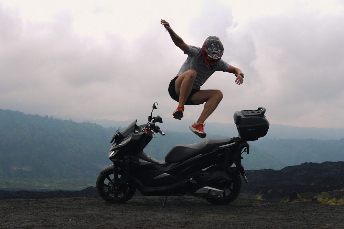 a man jumping off a motorcycle
